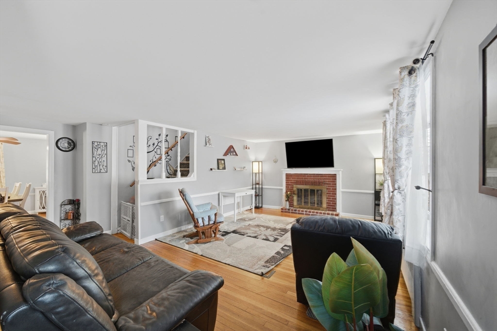8 Flint Street Chelmsford, MA 01824 - Photo 7 of 20 a living room with furniture and a flat screen tv