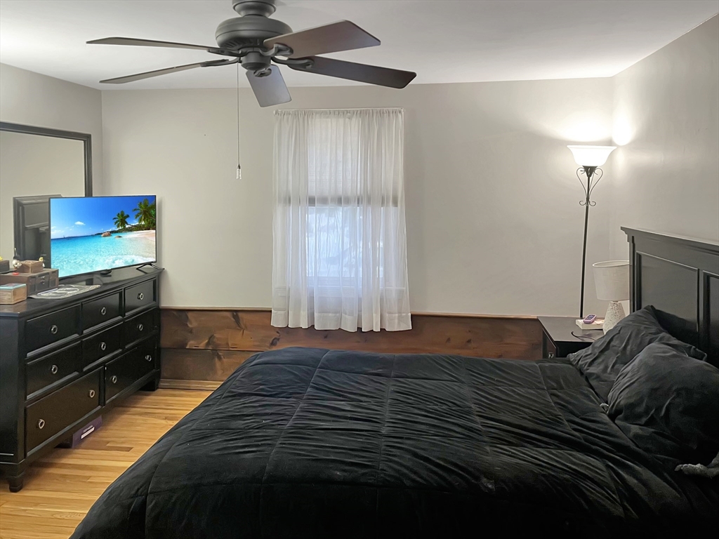 8 Flint Street Chelmsford, MA 01824 - Photo 8 of 20 a bedroom with a bed and a flat tv screen on the dresser