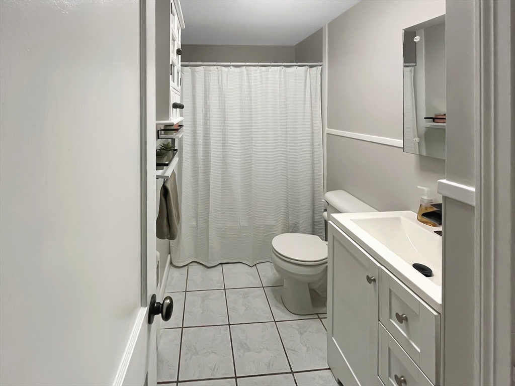 8 Flint Street Chelmsford, MA 01824 - Photo 10 of 20 a bathroom with a sink a toilet and shower