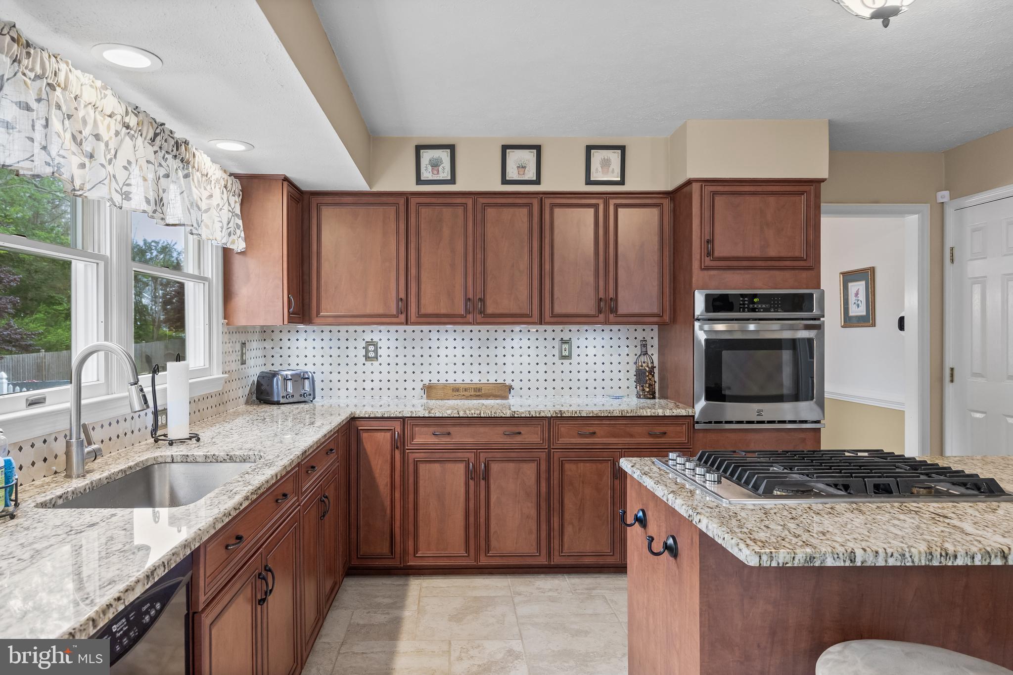 536 Justice Drive Marlton, NJ 08053 - Photo 13 of 44 a kitchen with stainless steel appliances granite countertop a stove sink and cabinets