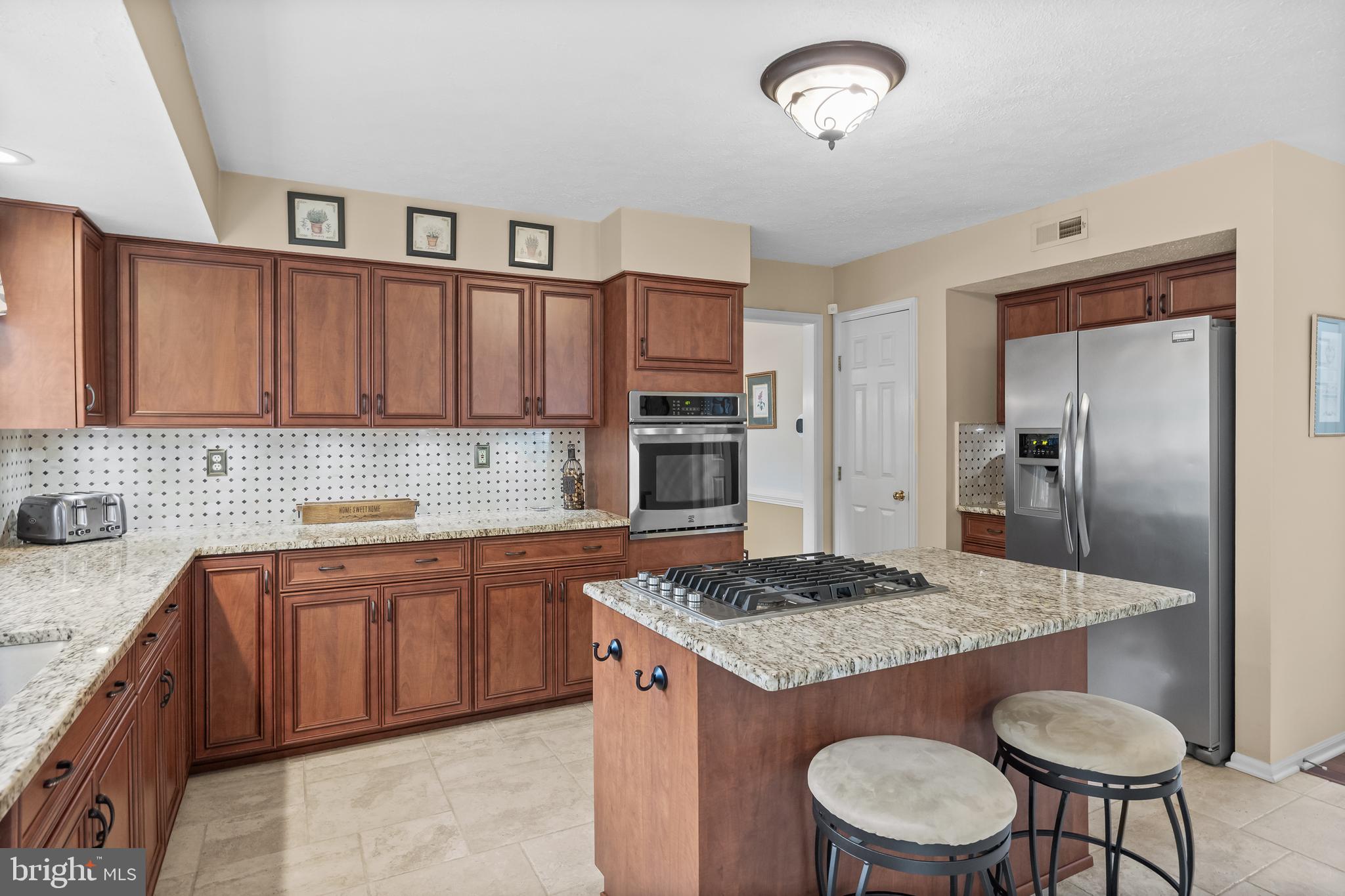 536 Justice Drive Marlton, NJ 08053 - Photo 14 of 44 a kitchen with granite countertop kitchen island stainless steel appliances a sink stove and refrigerator