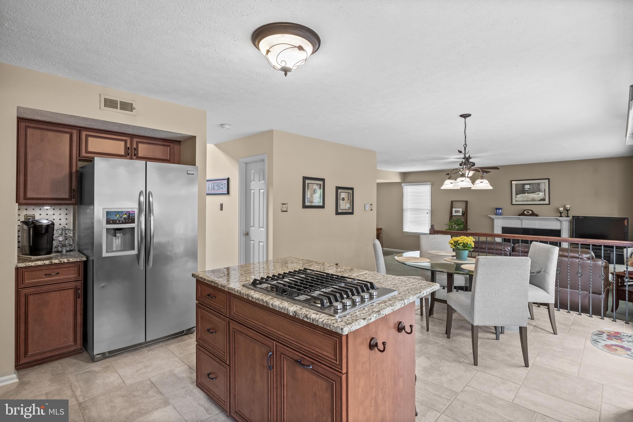536 Justice Drive Marlton, NJ 08053 - Photo 15 of 44 a kitchen with stainless steel appliances granite countertop a stove refrigerator a dining table and chairs with wooden floor