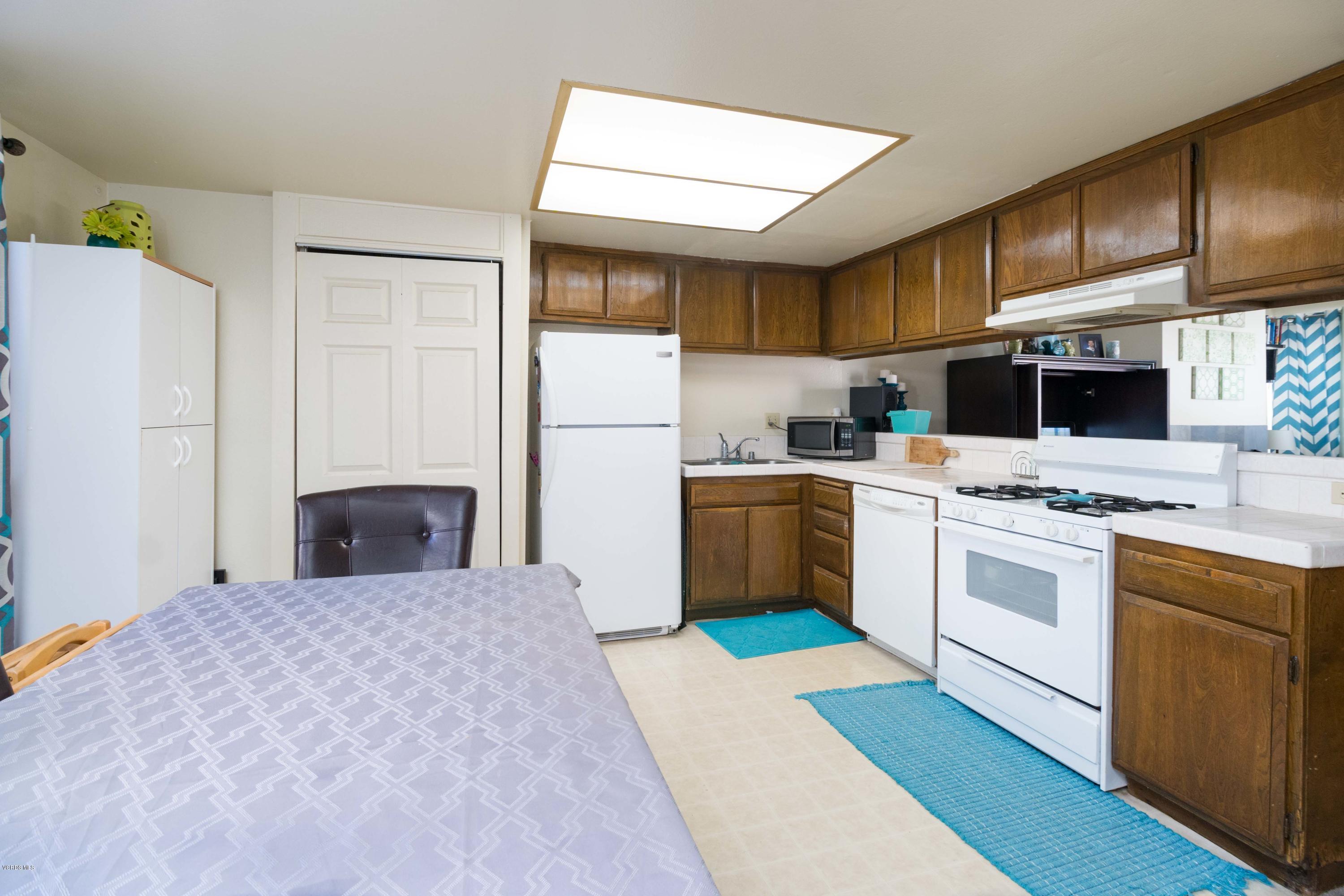 5117 West Wooley Road, Unit 3 Oxnard, CA 93035 - Photo 5 of 23 a kitchen with stainless steel appliances a stove a sink and a refrigerator