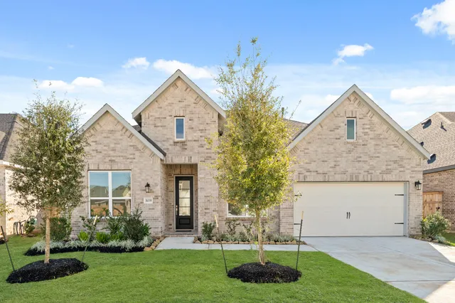 a front view of house with yard and green space