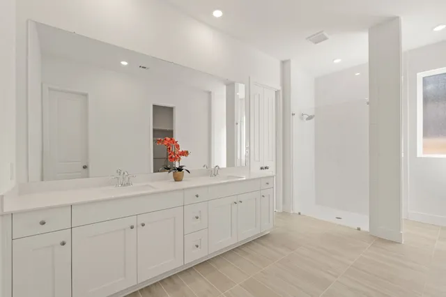 a bathroom with a double vanity sink mirror and double