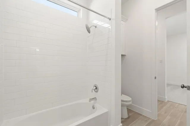 a bathroom with a bathtub and a toilet