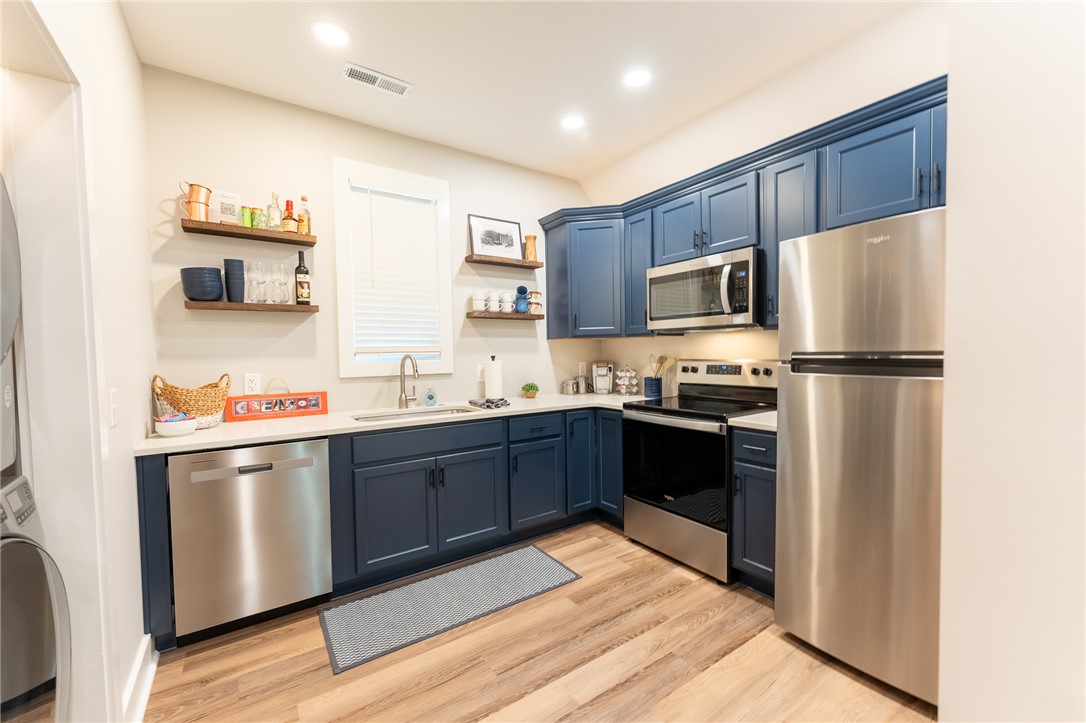 103 Riggs Drive Clemson, SC 29631 - Photo 40 of 50 A well-equipped kitchen features a stainless steel appliance suite and vibrant blue cabinetry.
