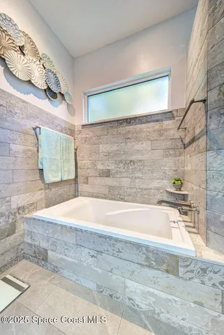 a bathroom with a granite countertop sink a toilet and mirror