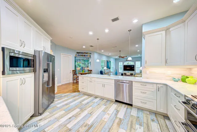 a kitchen with a refrigerator oven stove and a sink