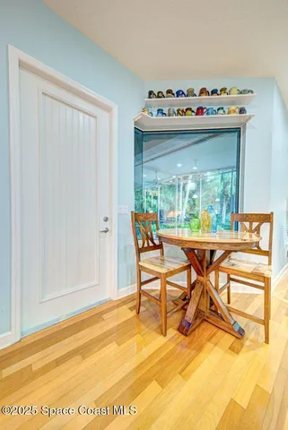 a dining room with furniture and wooden floor