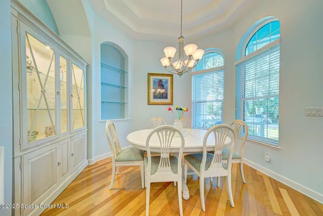 a view of a dining room with furniture and a chandelier