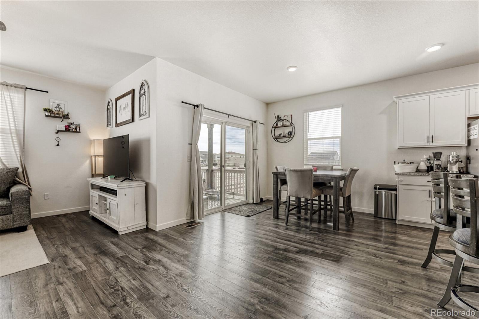 166 Racer Street Bennett, CO 80102 - Photo 14 of 44 a living room with furniture and a flat screen tv