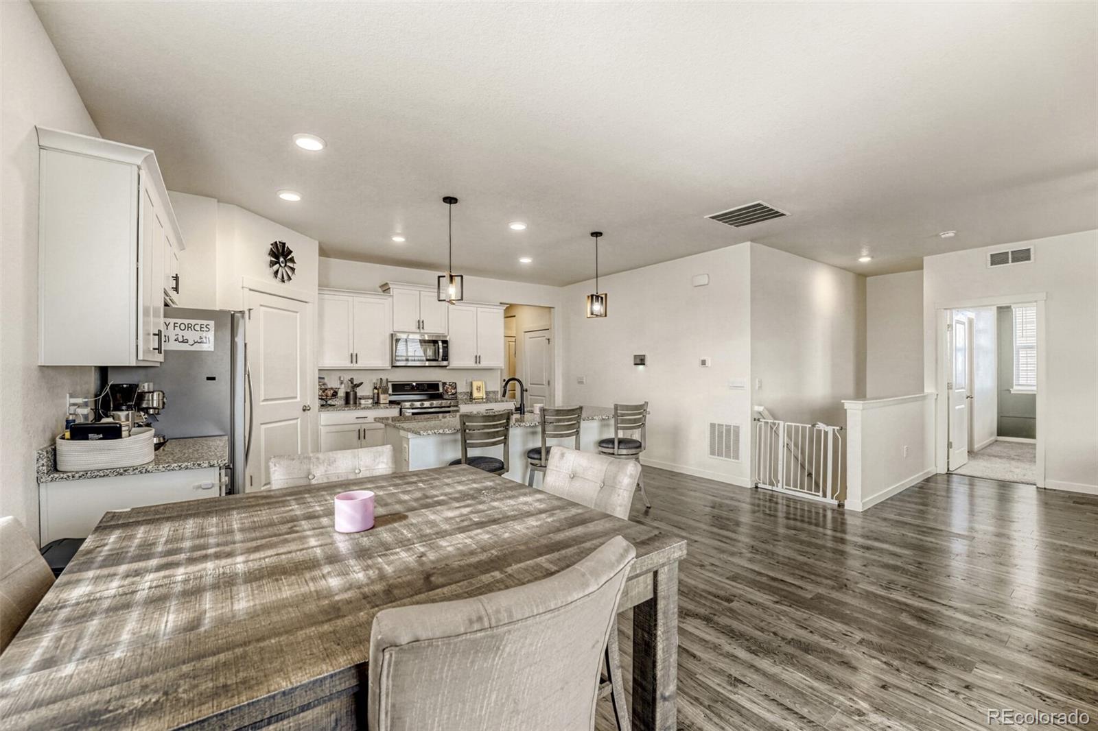 166 Racer Street Bennett, CO 80102 - Photo 15 of 44 a large kitchen with a large counter top appliances and cabinets