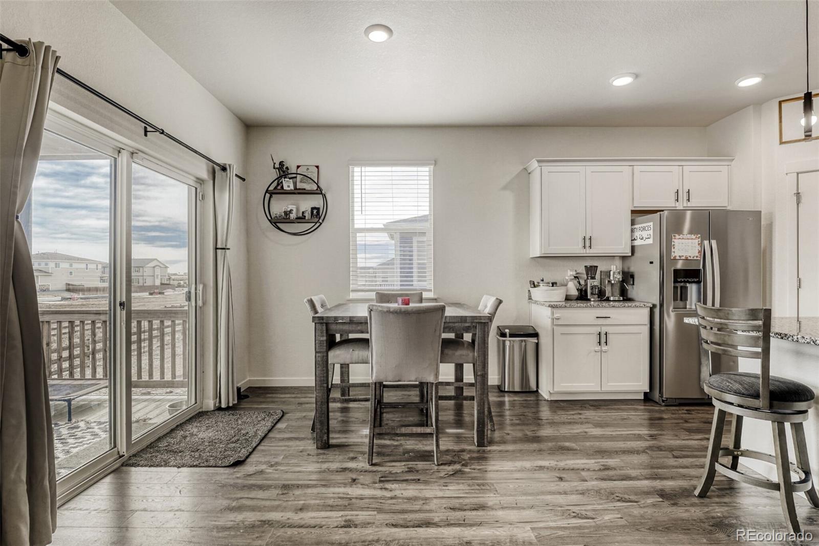 166 Racer Street Bennett, CO 80102 - Photo 16 of 44 a view of kitchen with cabinets and wooden floor