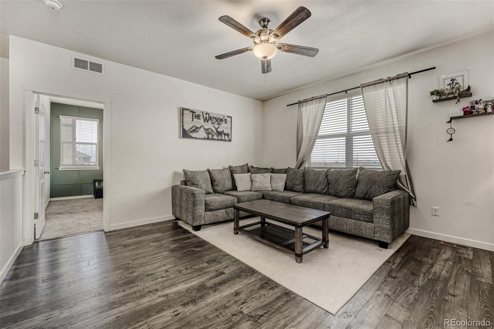 166 Racer Street Bennett, CO 80102 - Photo 19 of 44 a living room with furniture and a large window