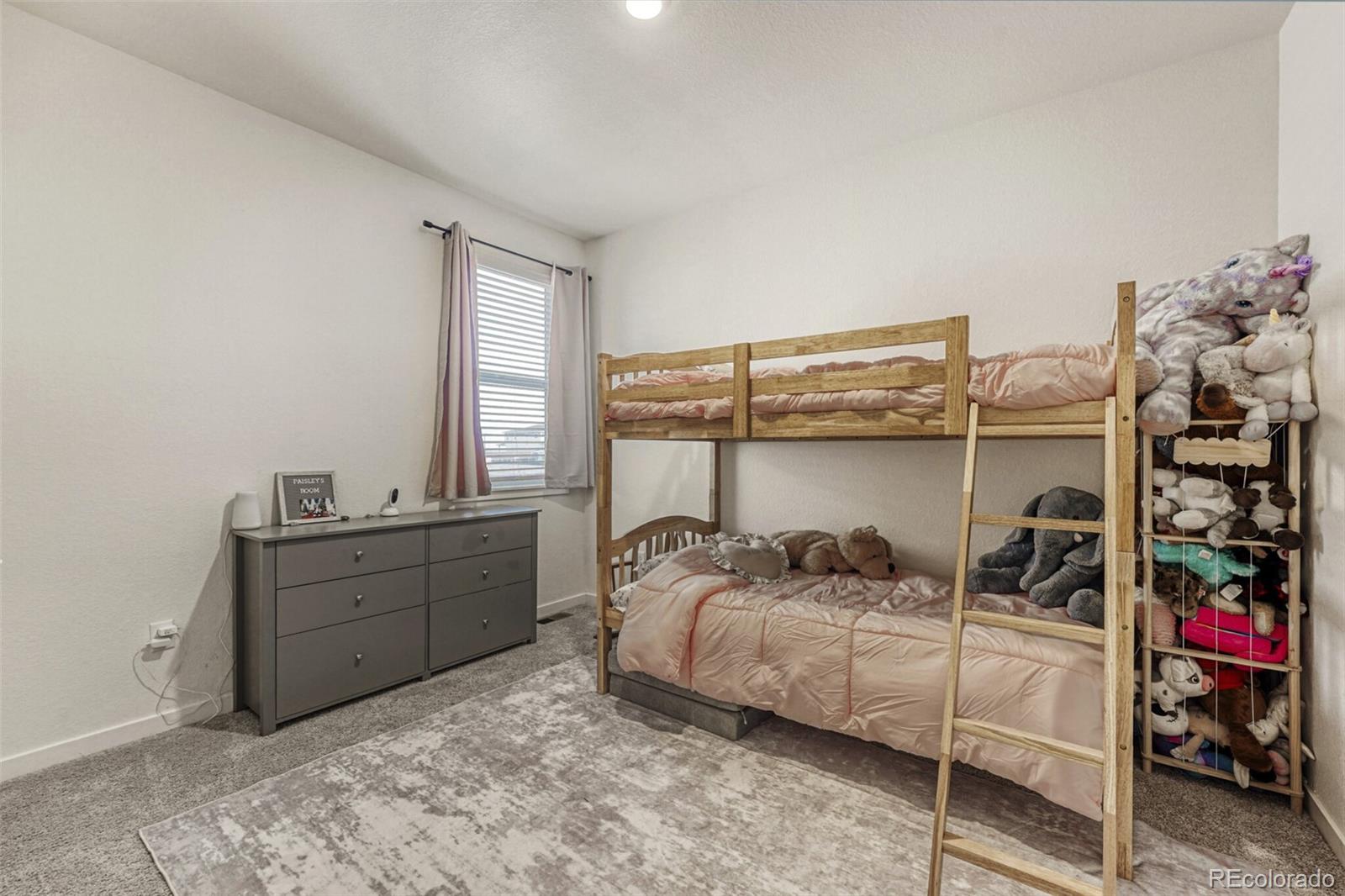 166 Racer Street Bennett, CO 80102 - Photo 28 of 44 a bedroom with a bed and a window