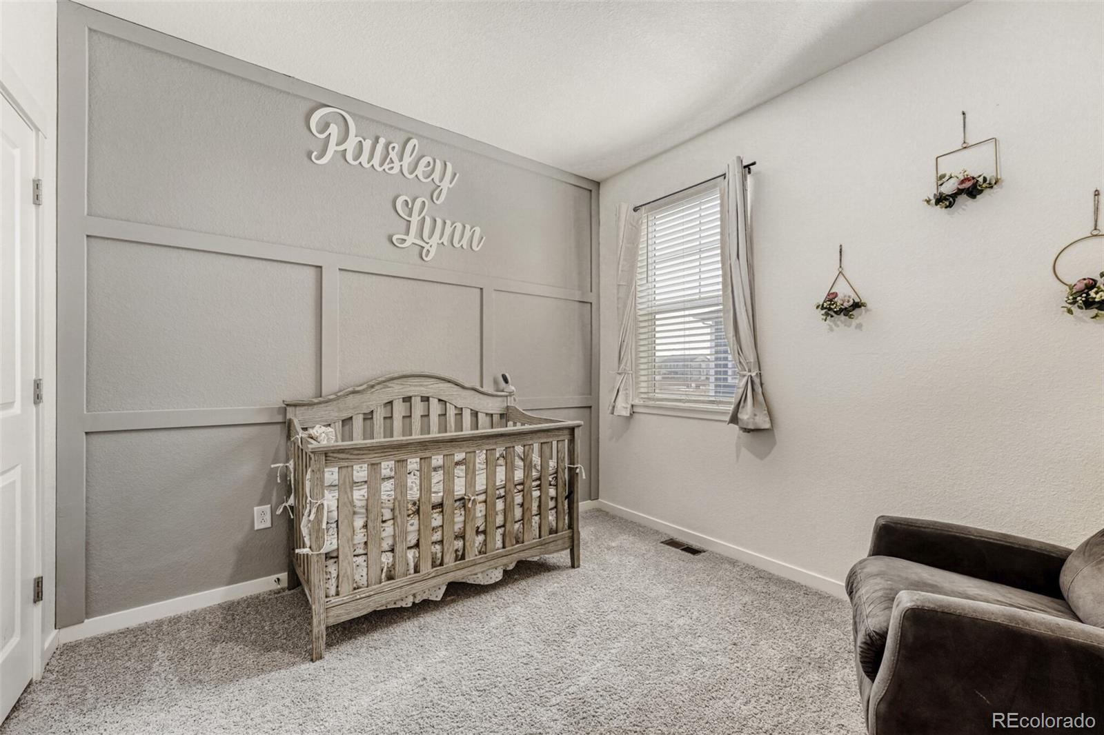 166 Racer Street Bennett, CO 80102 - Photo 30 of 44 a bedroom with furniture and a window