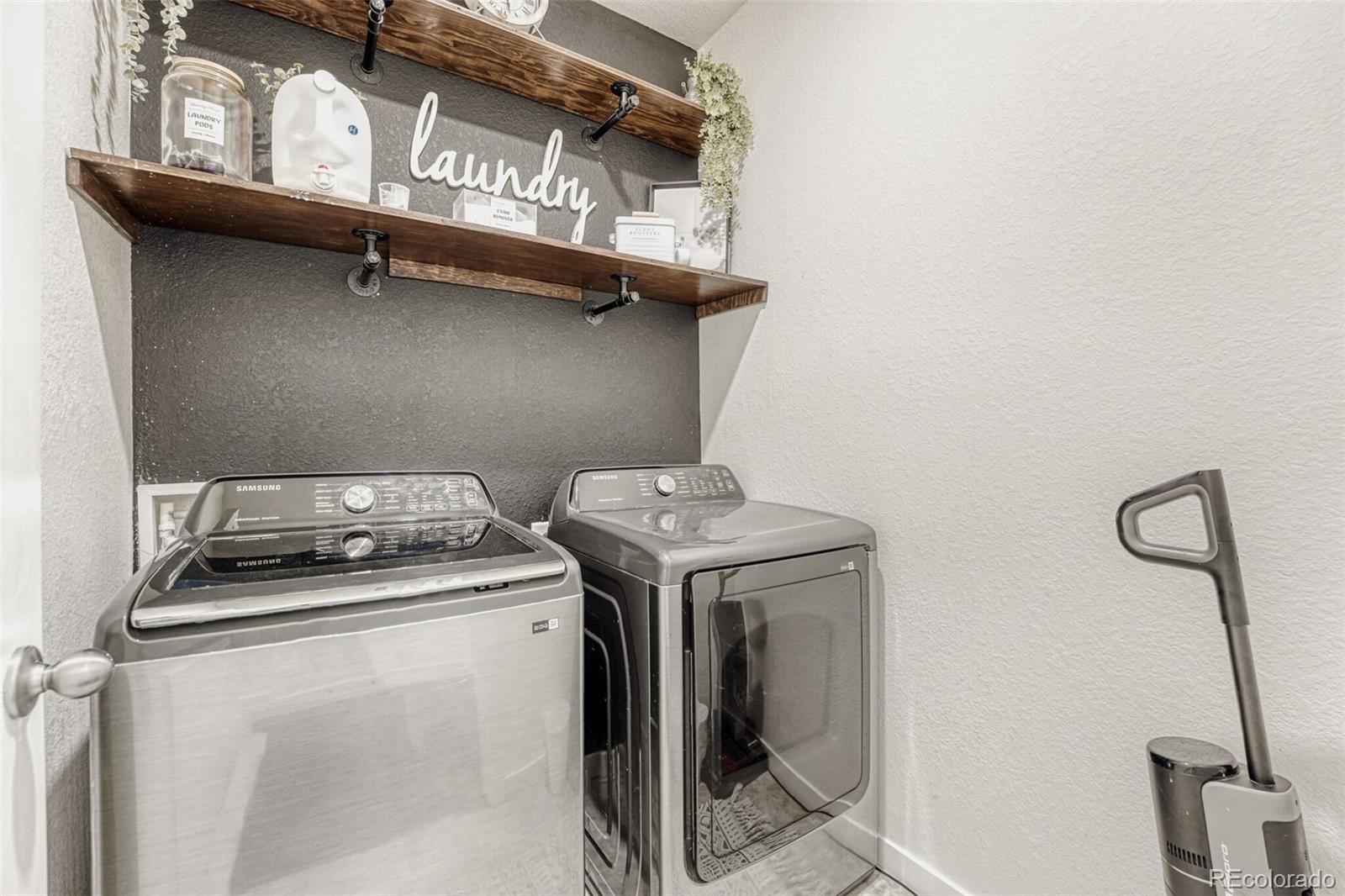 166 Racer Street Bennett, CO 80102 - Photo 33 of 44 a utility room with dryer and washer
