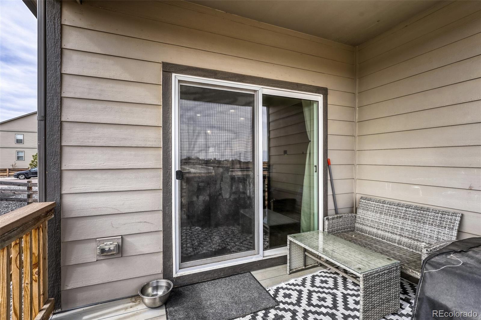 166 Racer Street Bennett, CO 80102 - Photo 38 of 44 a view of a house with a door and balcony