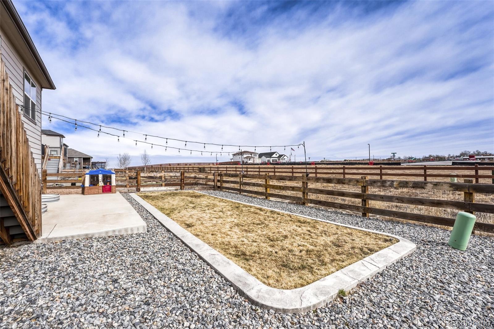 166 Racer Street Bennett, CO 80102 - Photo 43 of 44 a view of swimming pool with a yard