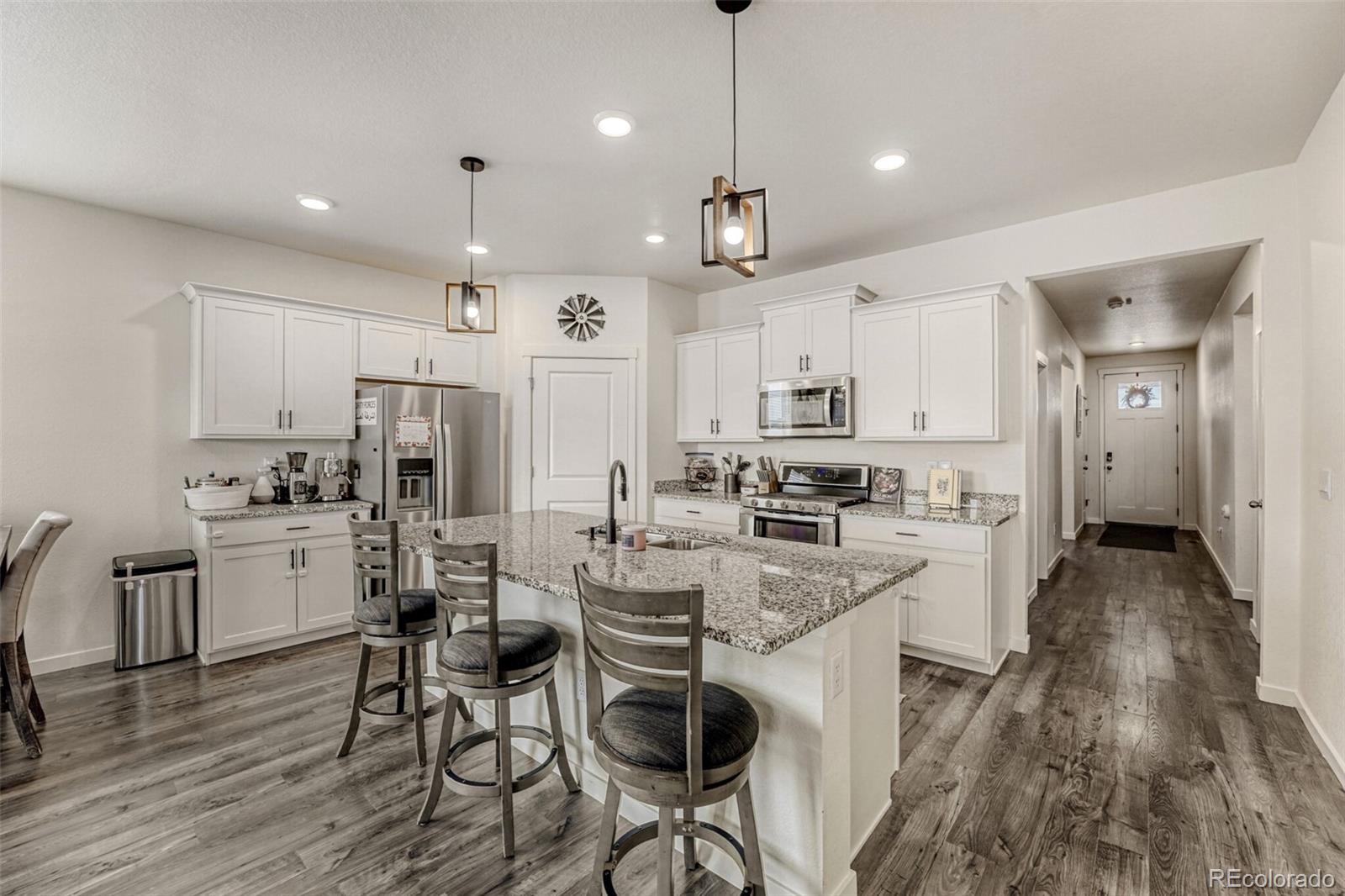 166 Racer Street Bennett, CO 80102 - Photo 10 of 44 a kitchen with refrigerator and cabinets