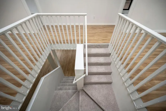 a view of entryway with wooden floor and stairs