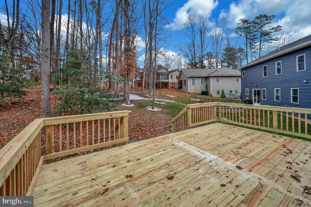 a view of a house with wooden fence