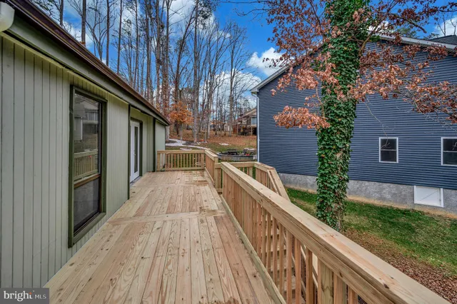 a view of balcony with wooden floor and fence