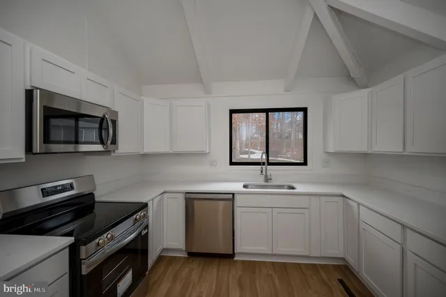 a kitchen with a sink stove and microwave