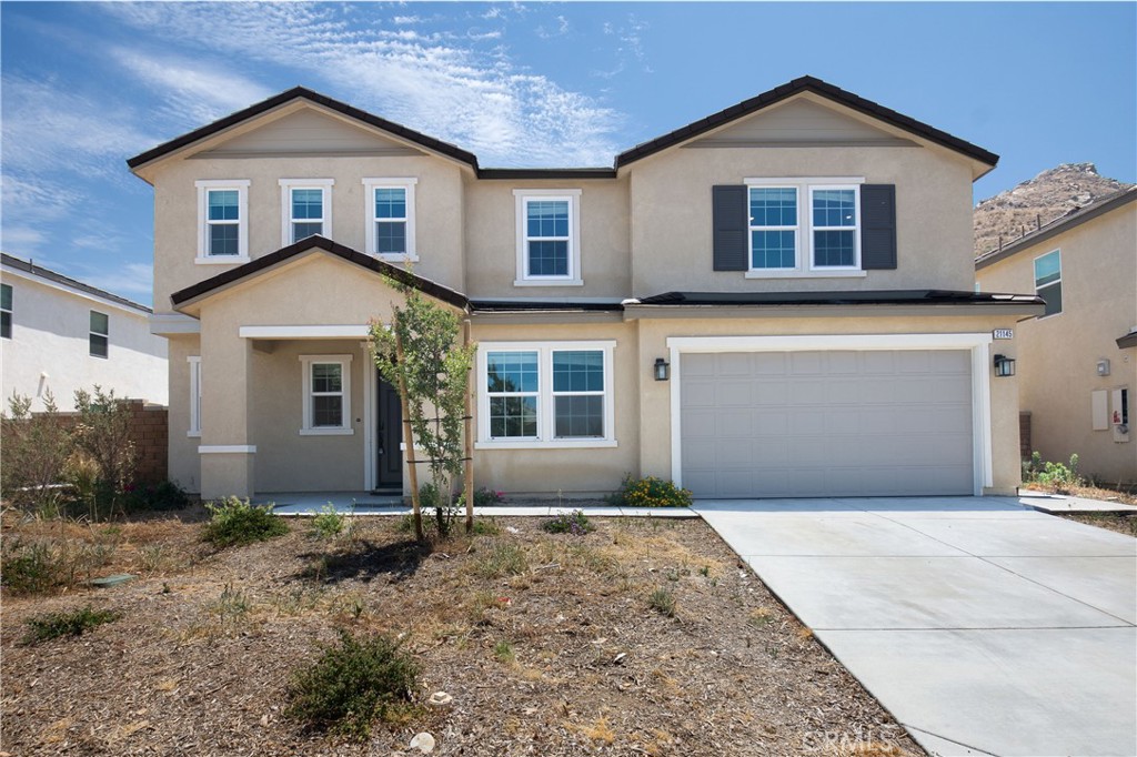 21145 Sutter Creek Riverside, CA 92507 - Photo 1 of 1 a front view of a house with a yard and garage