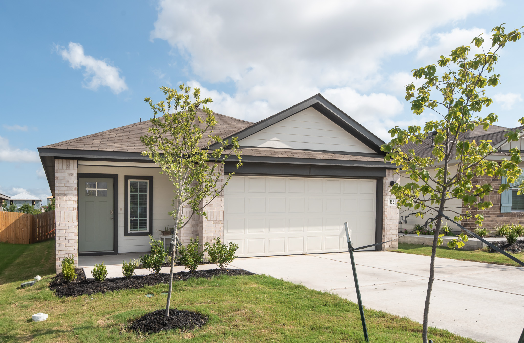 165 Santa Rosa Lane Buda, TX 78610 - Photo 2 of 21 a front view of a house with garden