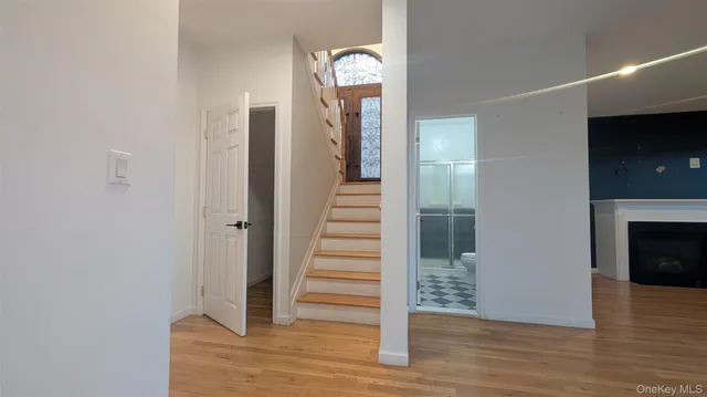 a view of a hallway with wooden floor and staircase