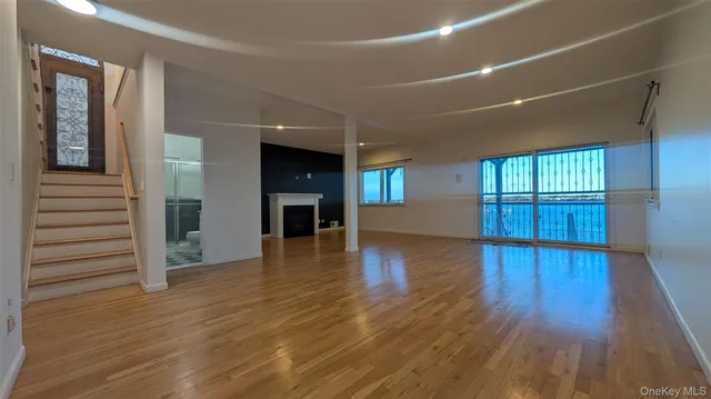 wooden floor in an empty room with a window