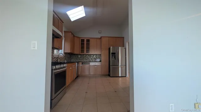 a kitchen with stainless steel appliances a refrigerator and a stove