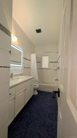 a bathroom with a granite countertop sink toilet and vanity