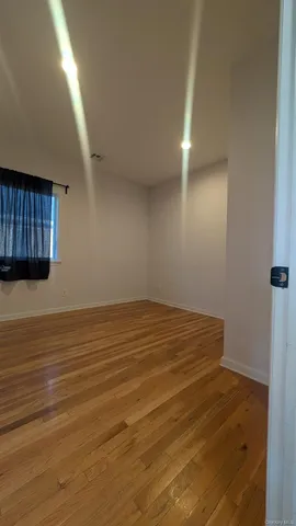 a view of a room with wooden floor and cabinet