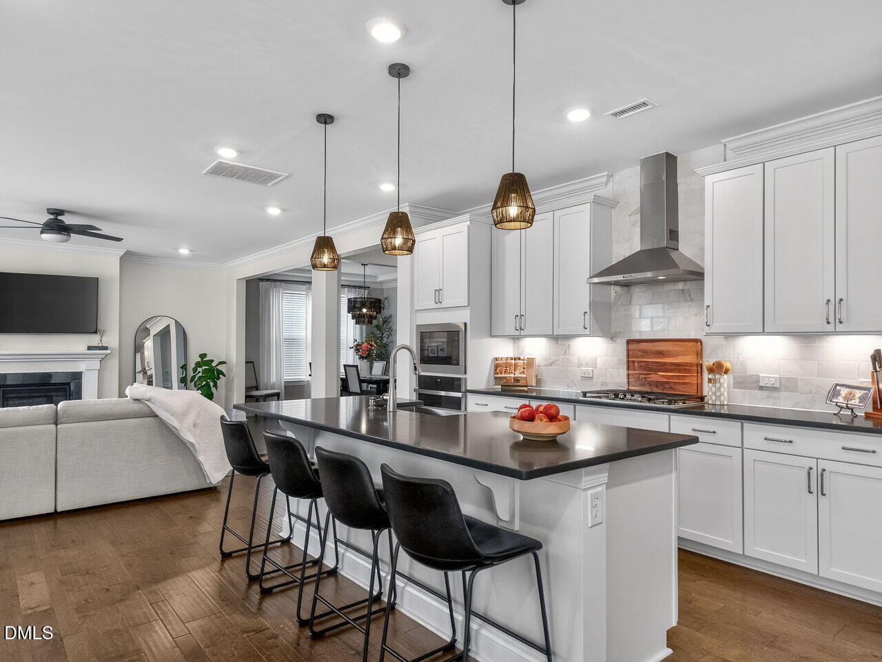 309 Toadstool Trail Wake Forest, NC 27587 - Photo 12 of 49 a kitchen with stainless steel appliances granite countertop a stove a sink a refrigerator and white cabinets with wooden floor