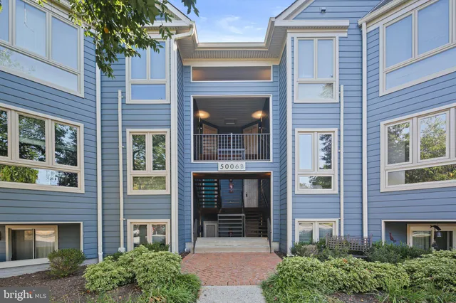 a front view of a brick house with a large windows