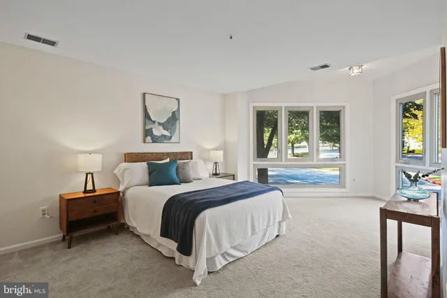 a spacious bedroom with a bed and a couch