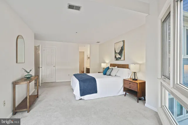 a bed room with a bed and a chair