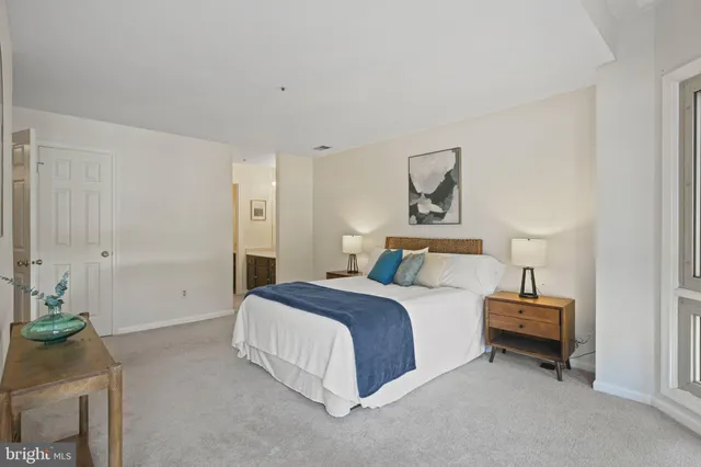 a spacious bedroom with a bed and a couch