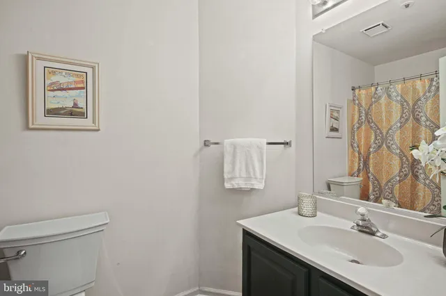 a bathroom with a sink vanity and a toilet