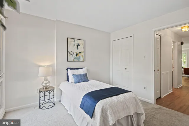 a bedroom with a bed and a lamp