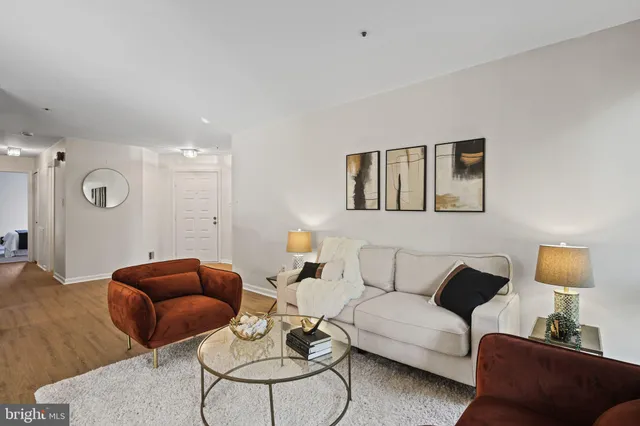 a living room with furniture a rug and a lamp