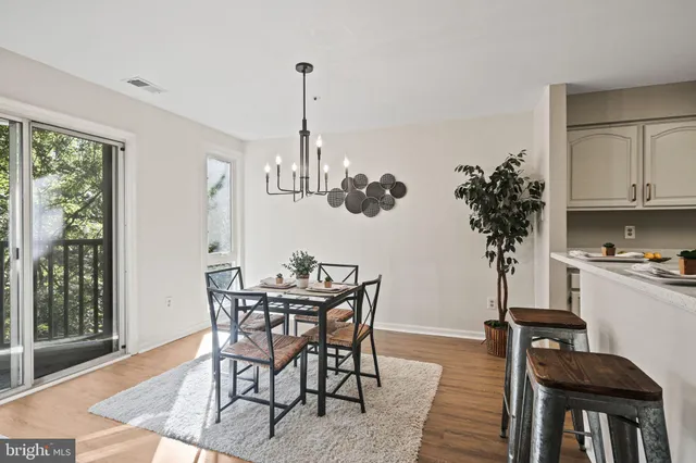 a view of a dining room with furniture and wooden floor