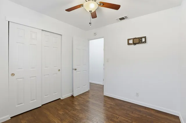 a bathroom with a shower sink vanity and toilet