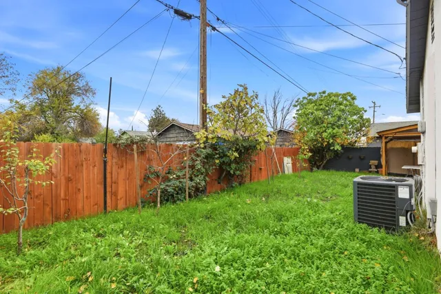 a backyard of a house with plants and outdoor seating