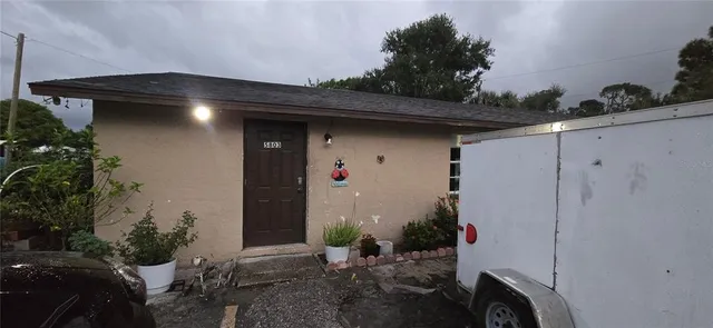 a couple of potted plants in front of door