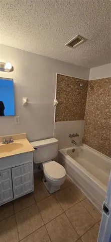 a bathroom with a sink a toilet and bathtub