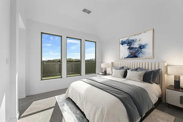 a bedroom with a large bed and a large window